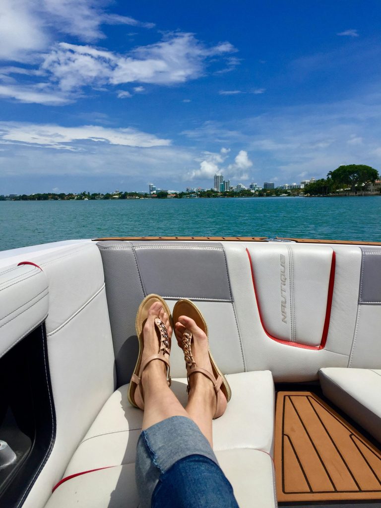 Relaxing yacht ride with feet up on deck during Custom Cat Charters trip