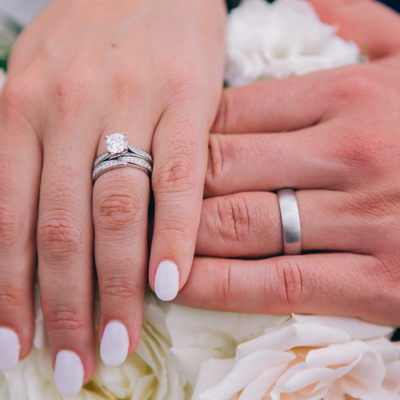 Bride and groom showing wedding rings during Custom Cat Charters celebration