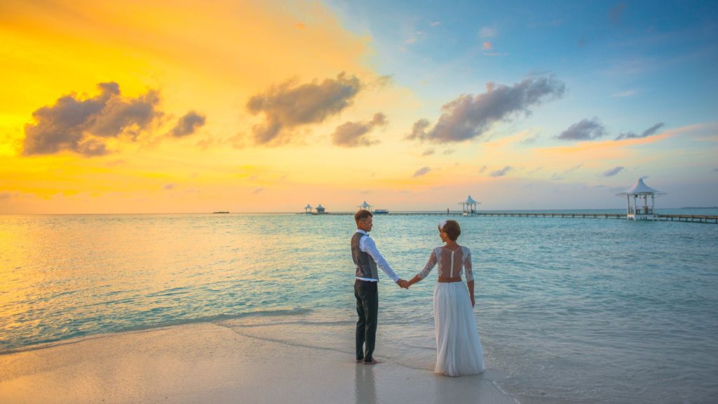 Couple standing in shallow turquoise water