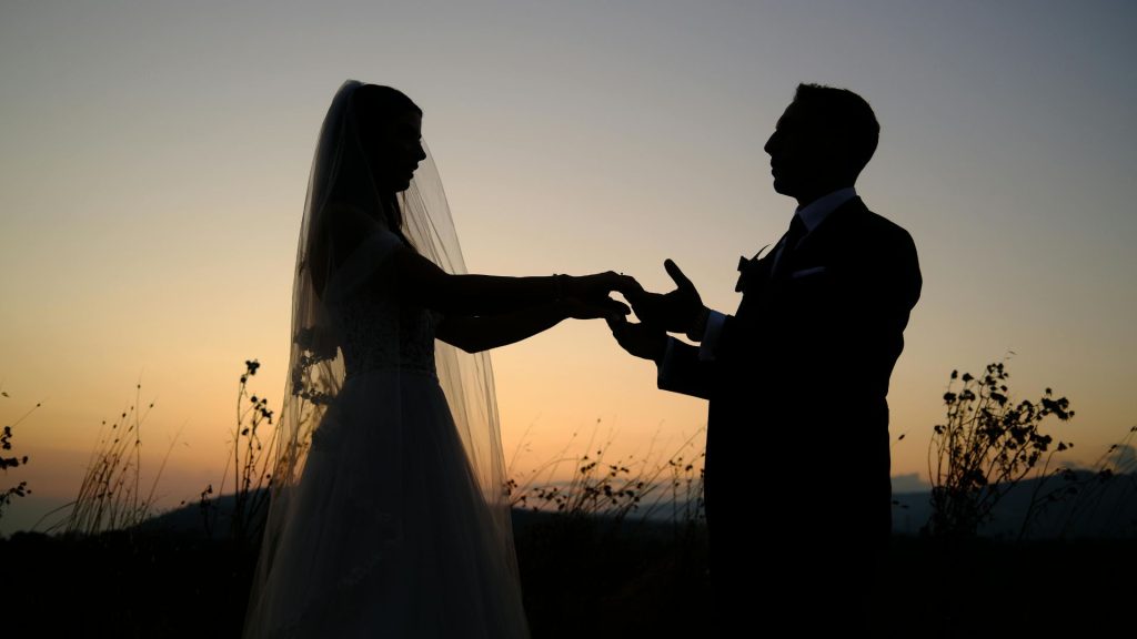 Romantic Florida Keys sunset beach proposal with couple holding hands during golden hour